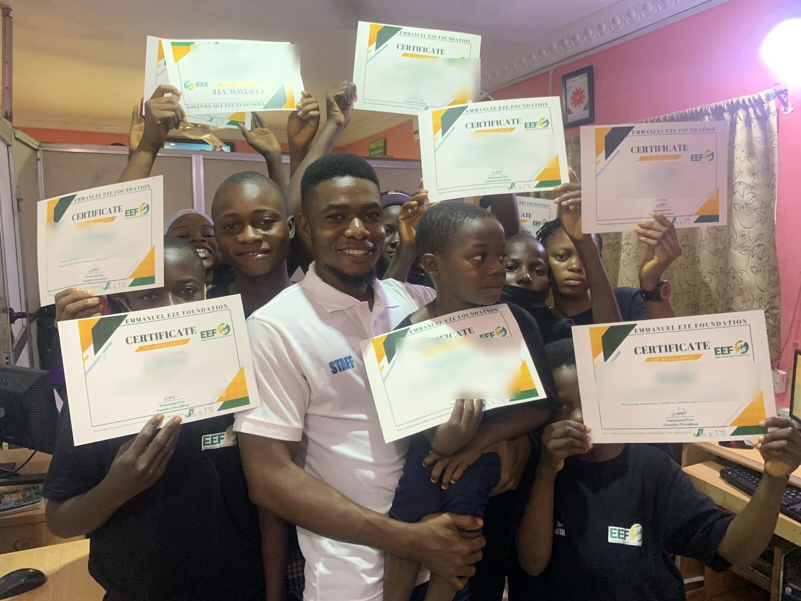 Certificate day. Students holding the certificates they earned in the computer training we paid for.